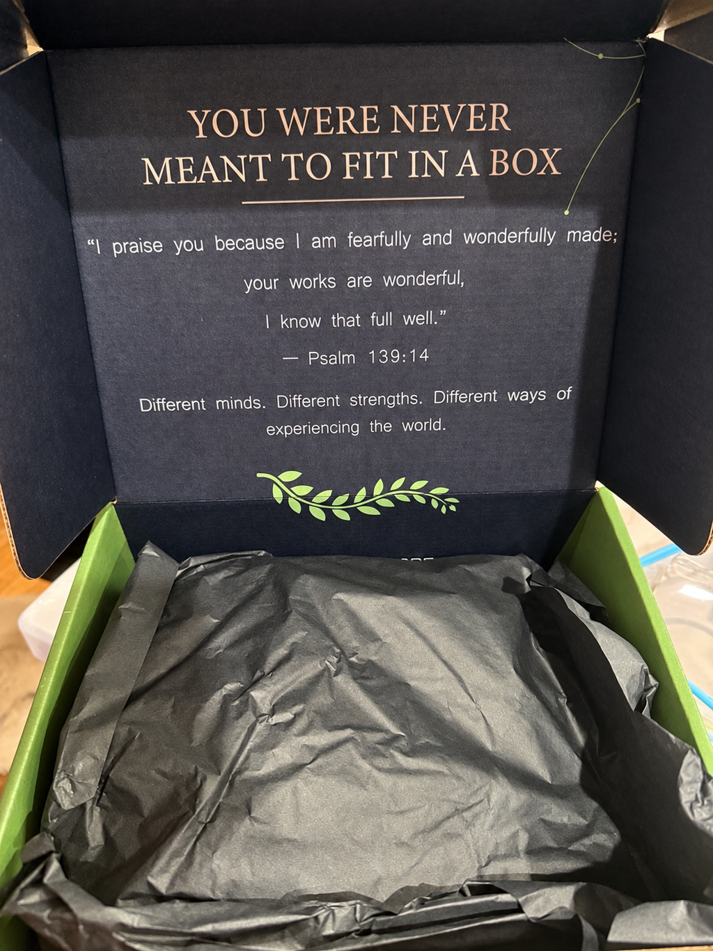 Open NeuroNest gift box with black tissue and Psalm 139:14 message