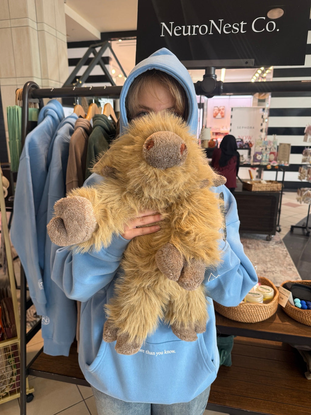 Light-blue NeuroNest LOVED. hoodie shown worn from the front