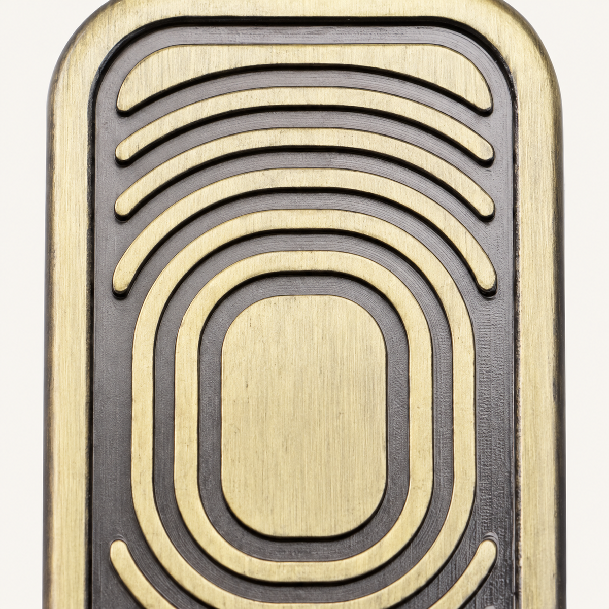 Close-up of the curved grooves on the brass-look Metal Slider Fidget