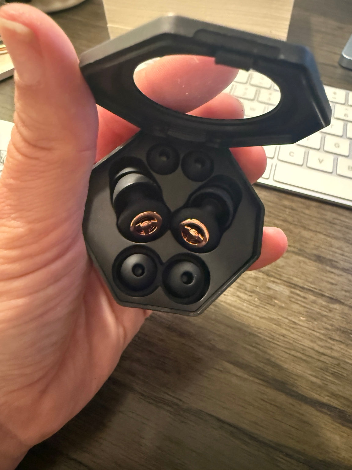 RESET earbuds and spare ear tips shown in a handheld open case