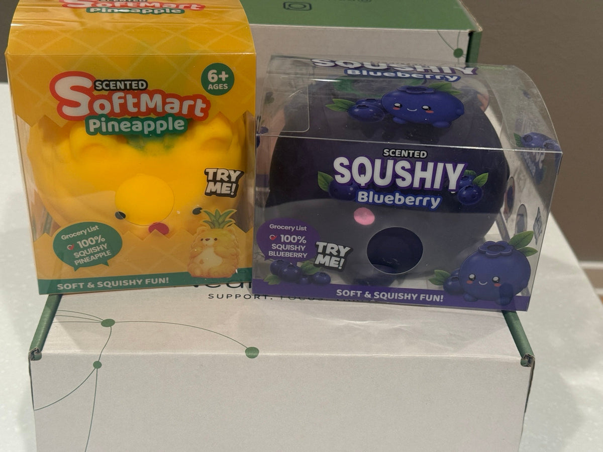 Pineapple and blueberry squishies in original retail packaging